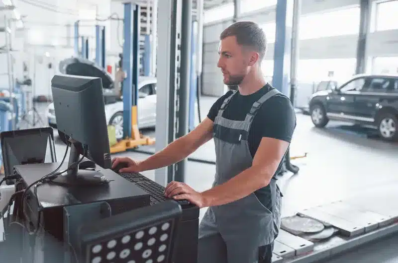 car tech looking at computer monitor