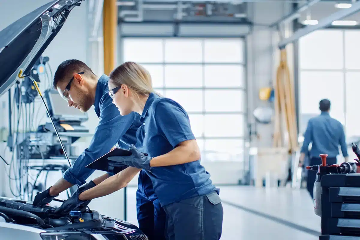 mechanics looking at vehicle engine