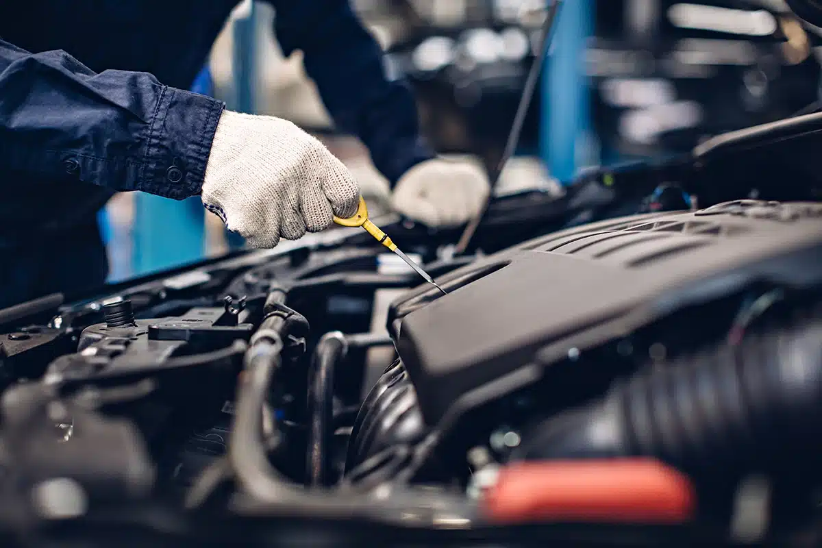 oil change tech under hood